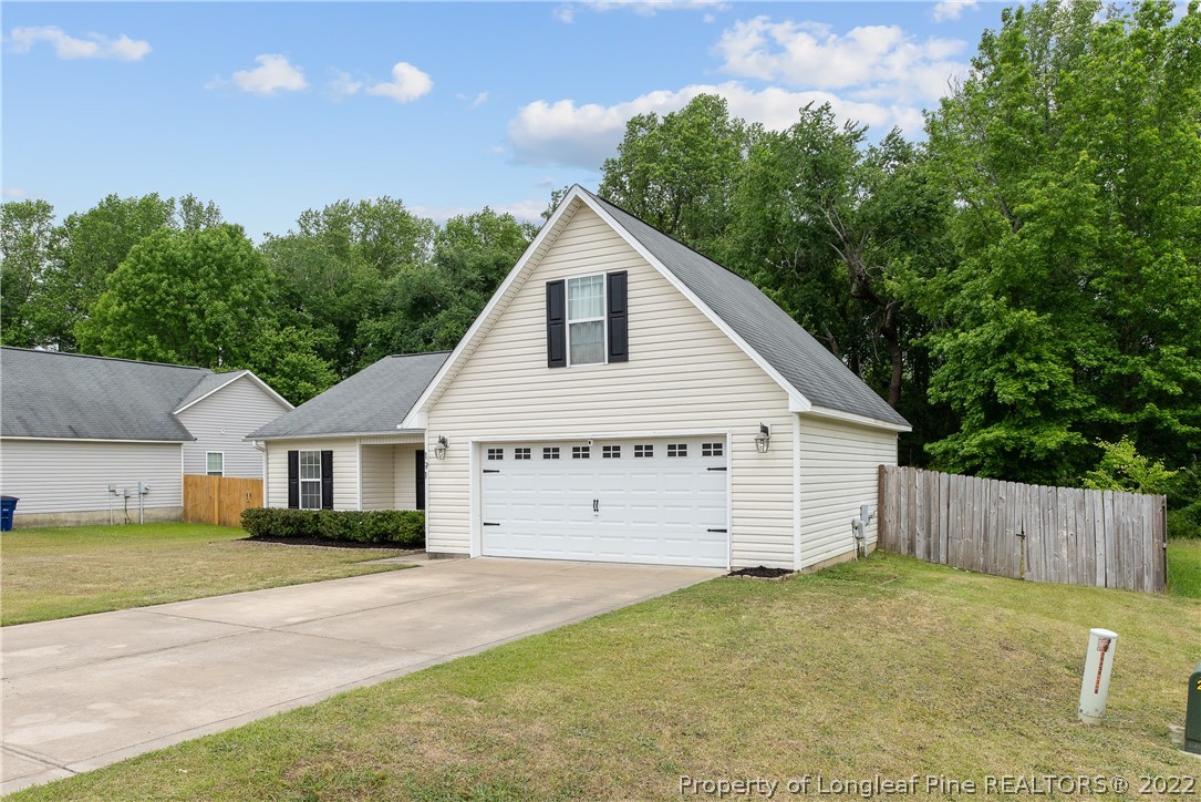 191 Quarry Lane Raeford, NC 28376 - Photo 3 of 42 a view of a house with a yard and garage