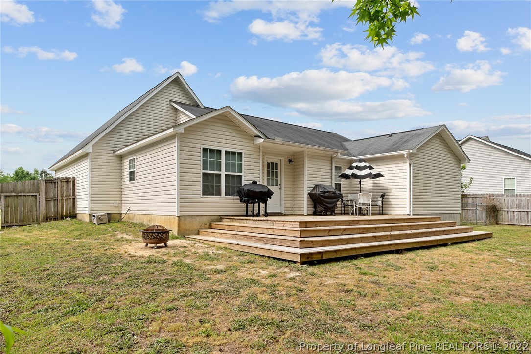 191 Quarry Lane Raeford, NC 28376 - Photo 39 of 42 a view of a house with a backyard and a tree