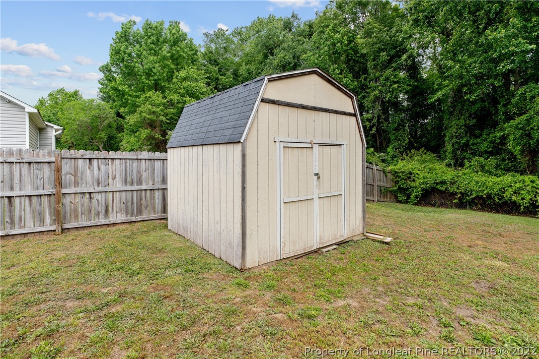 191 Quarry Lane Raeford, NC 28376 - Photo 42 of 42 a view of backyard with small cabin and wooden fence