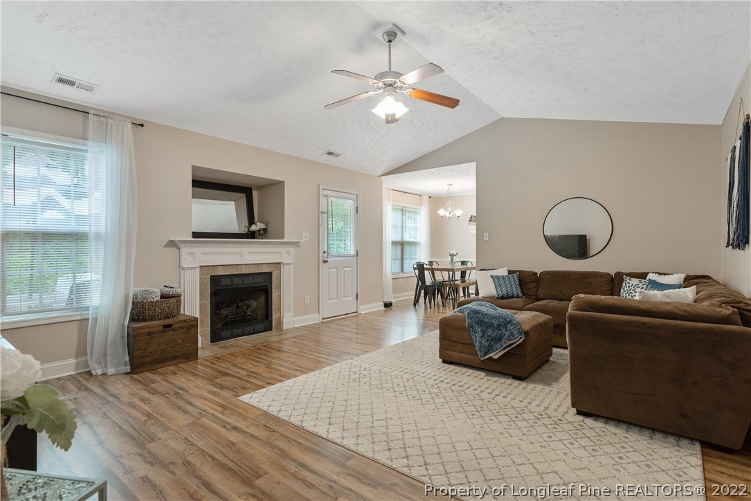 191 Quarry Lane Raeford, NC 28376 - Photo 7 of 42 a living room with furniture a fireplace and a flat screen tv