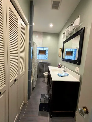 a view of a bathroom with a sink and mirror