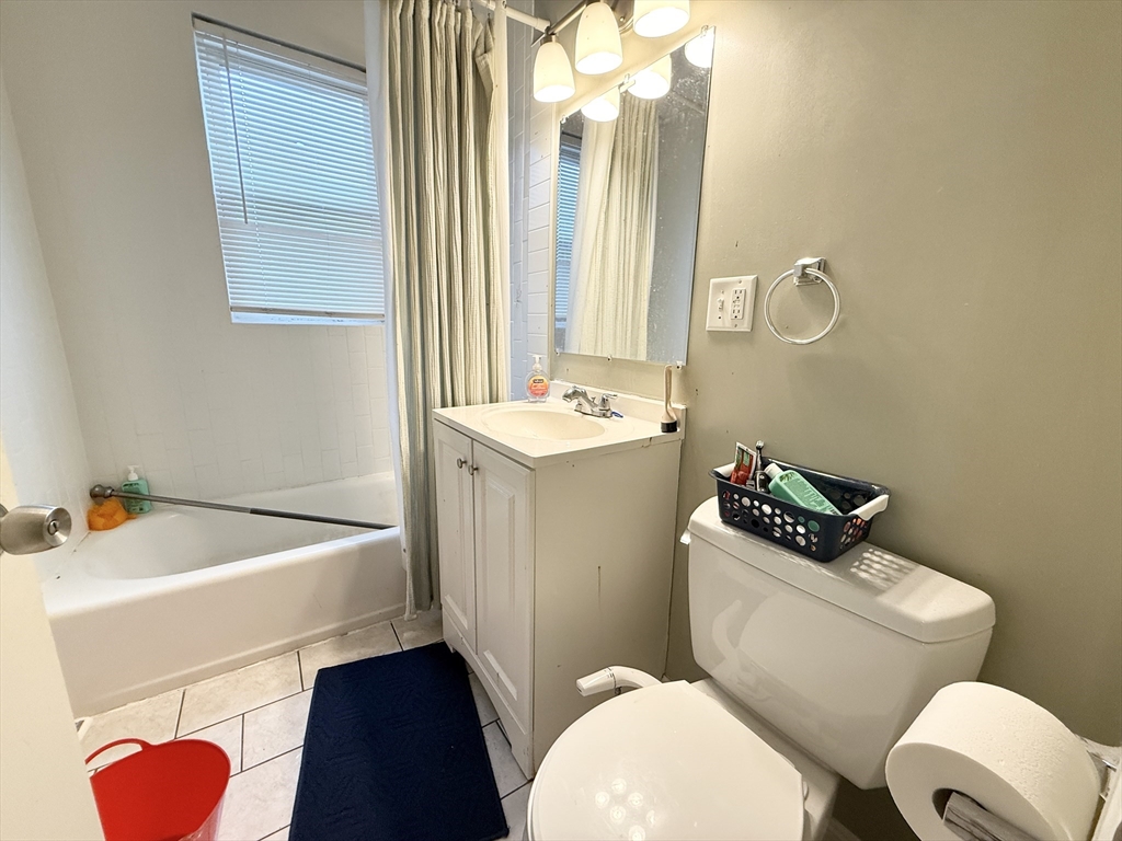 3977 Washington Street, Unit 3 Boston, MA 02131 - Photo 11 of 11 a bathroom with a sink a toilet and a mirror