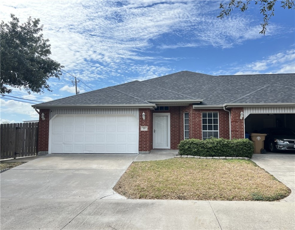 5026 Yorktown Boulevard, Unit 23 Corpus Christi, TX 78413 - Photo 1 of 29 a front view of a house with a yard and garage