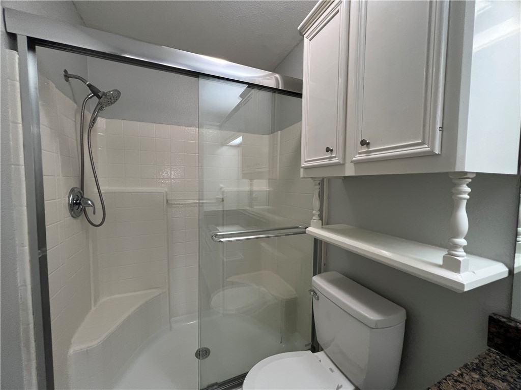 5026 Yorktown Boulevard, Unit 23 Corpus Christi, TX 78413 - Photo 18 of 29 a bathroom with a shower a toilet and sink