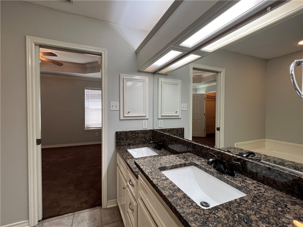 5026 Yorktown Boulevard, Unit 23 Corpus Christi, TX 78413 - Photo 23 of 29 a bathroom with a granite countertop sink and a mirror