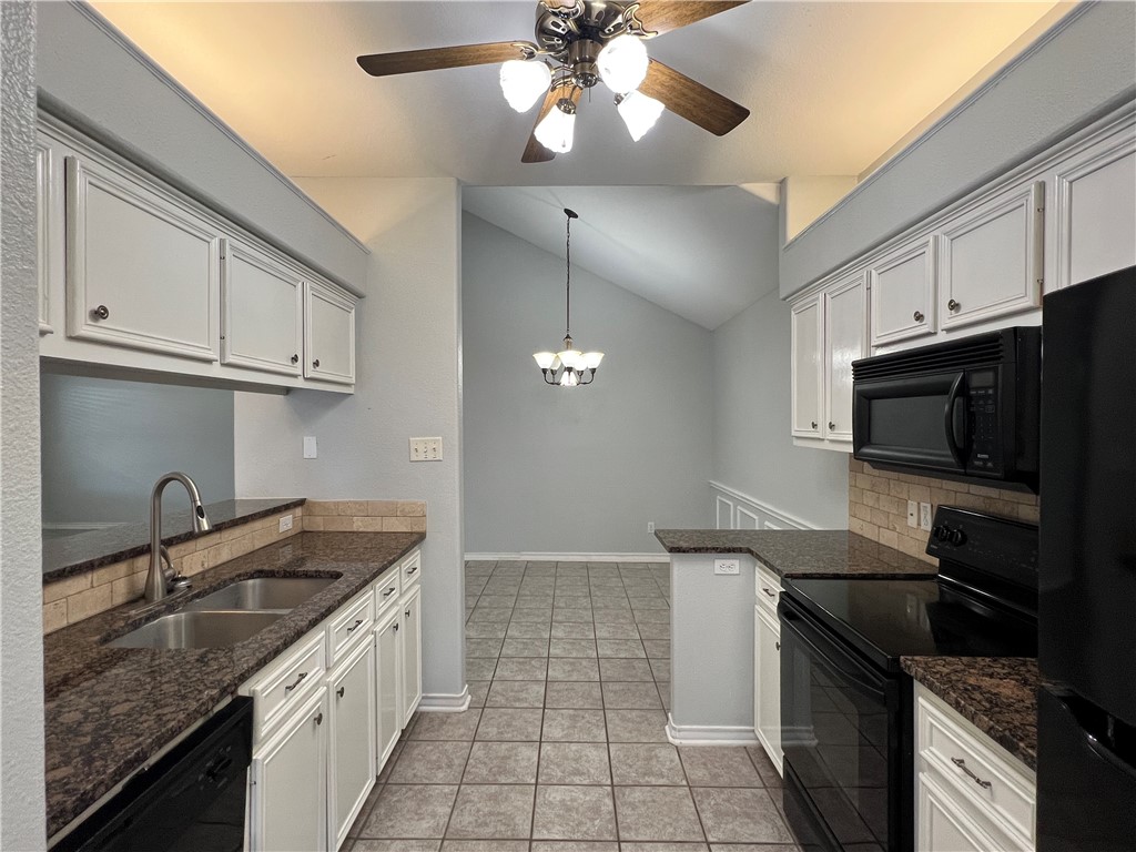 5026 Yorktown Boulevard, Unit 23 Corpus Christi, TX 78413 - Photo 9 of 29 a kitchen with stainless steel appliances granite countertop a sink a stove oven and cabinets
