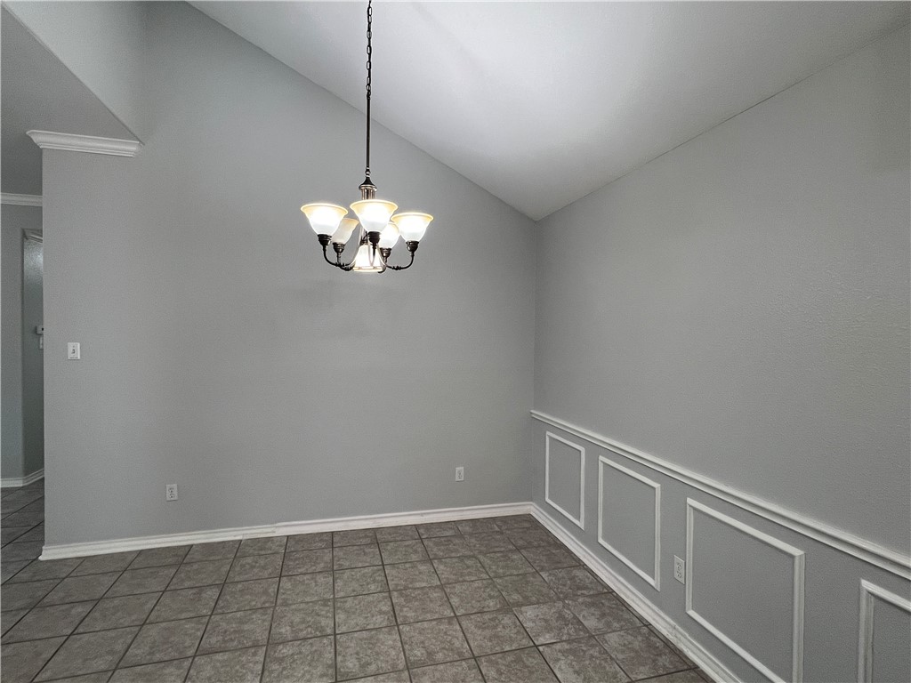 5026 Yorktown Boulevard, Unit 23 Corpus Christi, TX 78413 - Photo 10 of 29 a view of an empty room with chandelier fan