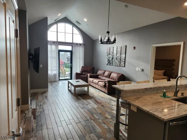 a living room with furniture window and wooden floor