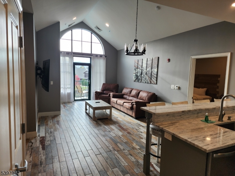 a living room with furniture window and wooden floor