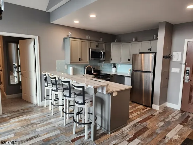 a kitchen with stainless steel appliances a refrigerator stove microwave and cabinets