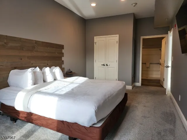 a bedroom with a bed and a night stand