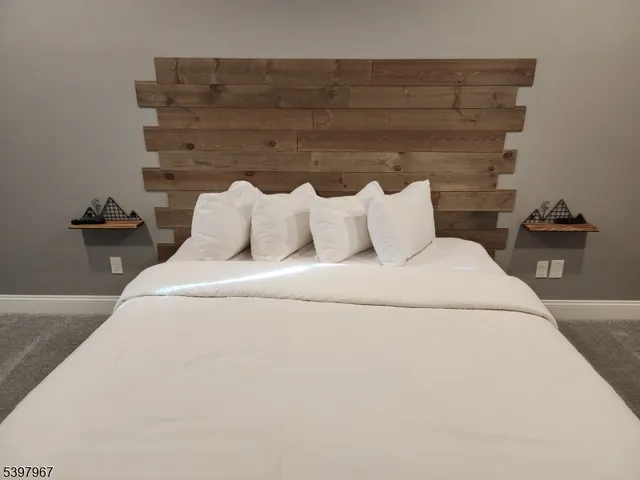 a bed sitting in a bedroom next to a window with potted plants