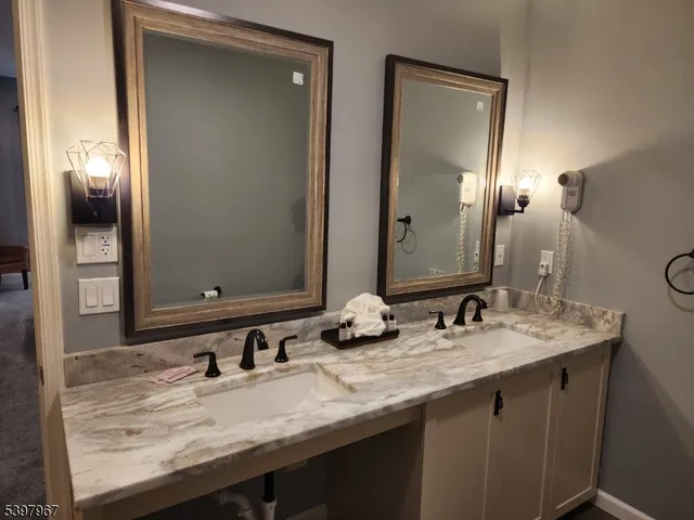 a bathroom with a granite countertop sink and a mirror