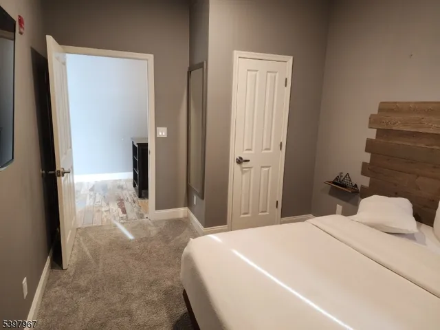 a bedroom with a bed and a mirror