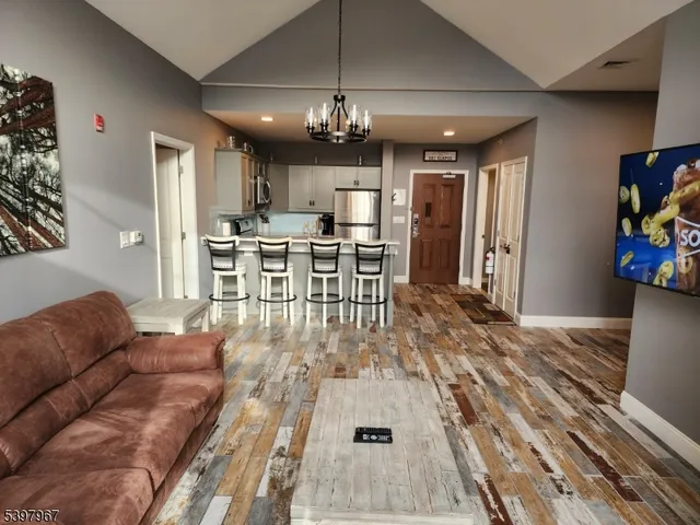 a living room with furniture and a chandelier