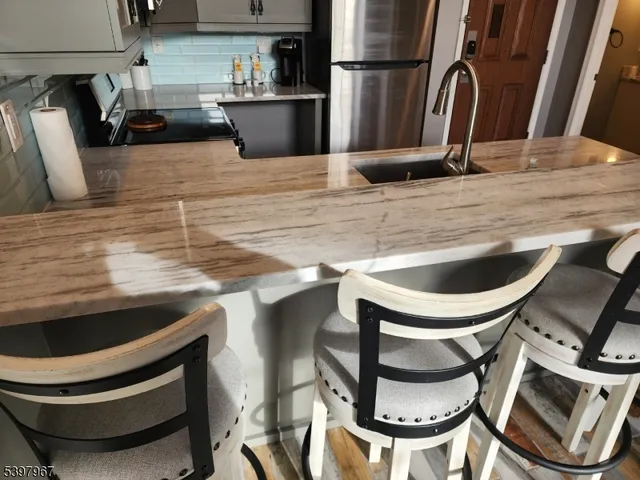 a kitchen with a sink appliances and cabinets