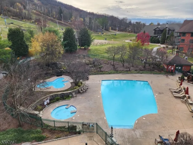 a view of a backyard with swimming pool