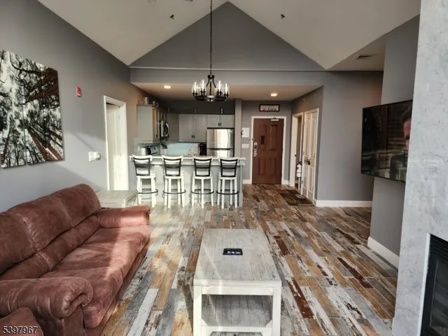 a living room with furniture a chandelier and a dining room