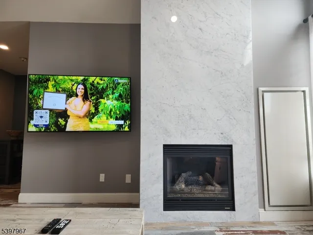 a room with a fireplace and a flat screen tv