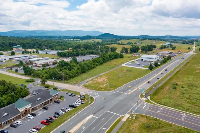 an aerial view of a residential houses with a swimming pool