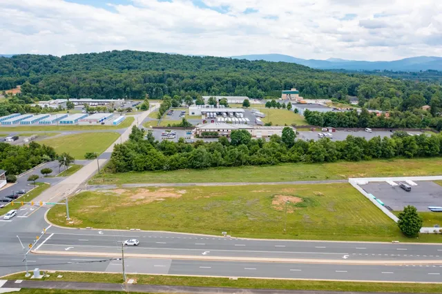 a view of a swimming pool with a lawn chairs under an umbrella
