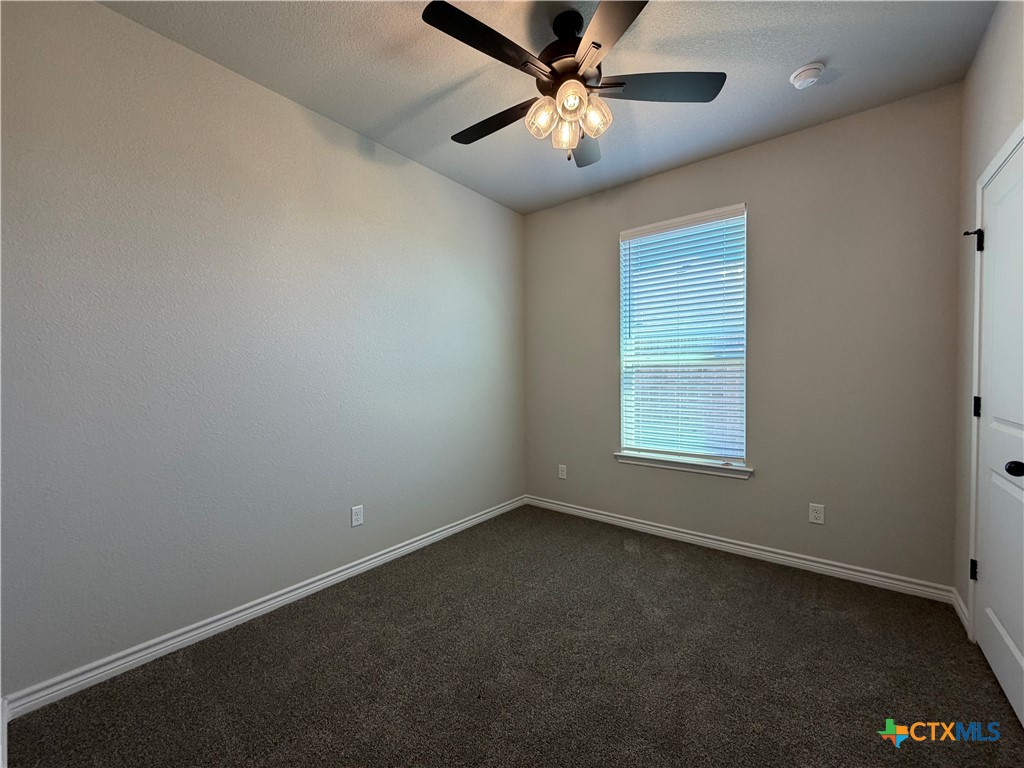 3008 Seeker Street Killeen, TX 76549 - Photo 17 of 25 an empty room with a window and a fan