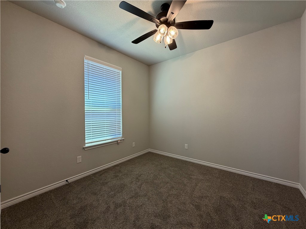 3008 Seeker Street Killeen, TX 76549 - Photo 19 of 25 an empty room with a window and a fan