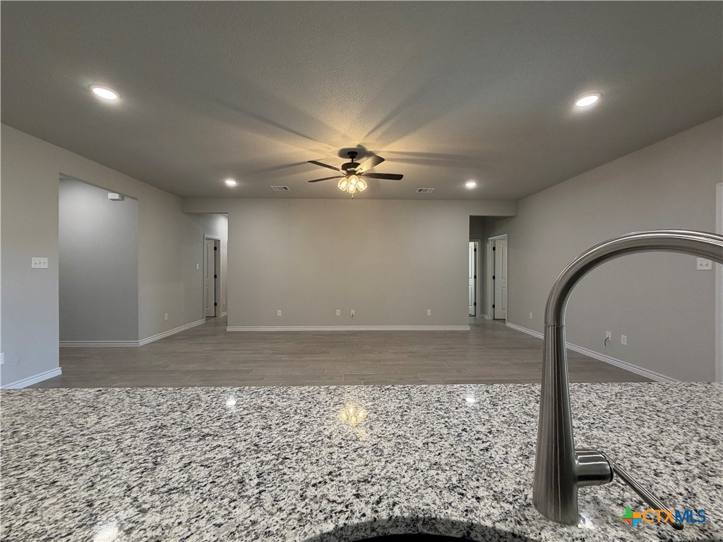 3008 Seeker Street Killeen, TX 76549 - Photo 9 of 25 a view of a livingroom with a ceiling fan and wooden floor