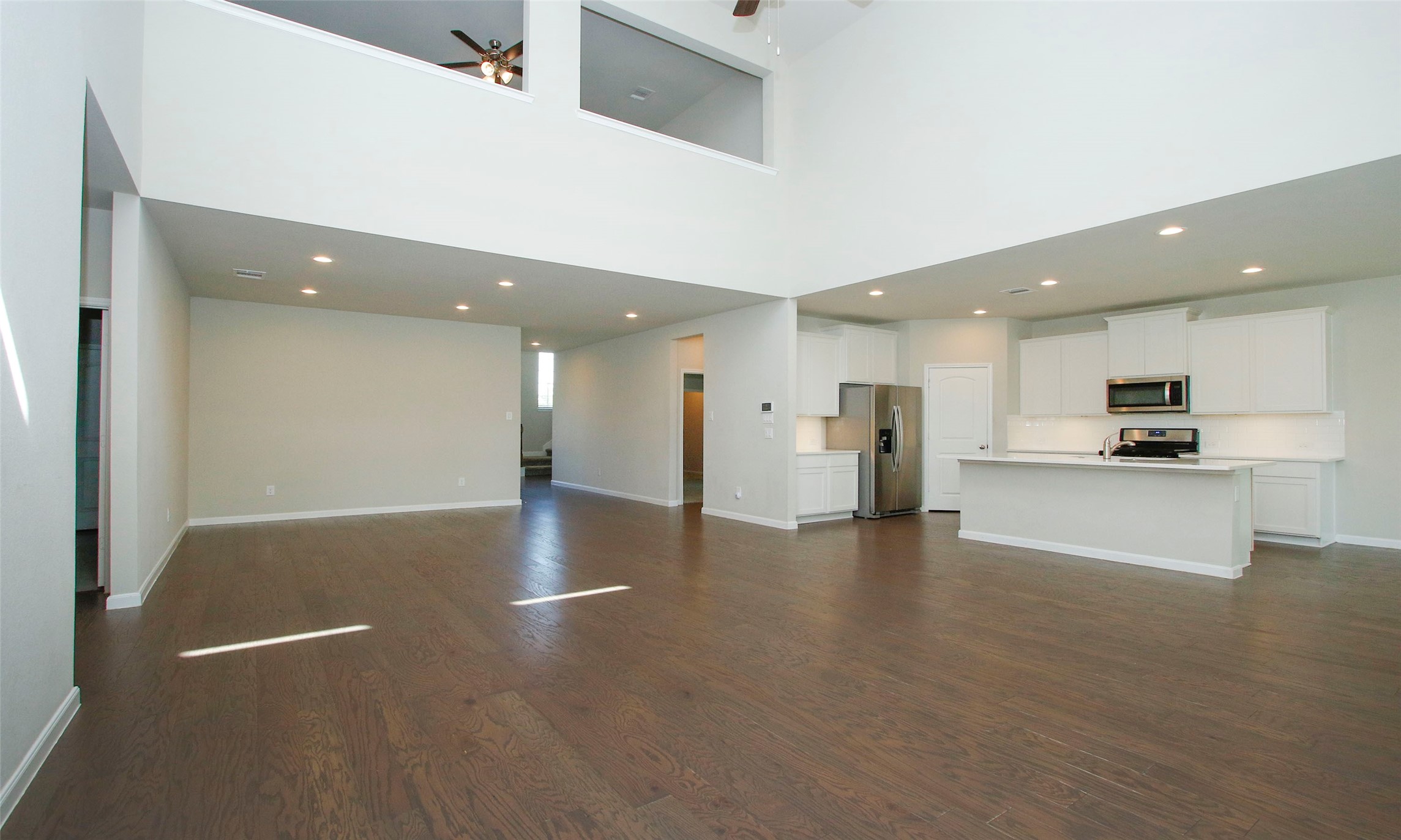 14120 Sand Ridge Court Conroe, TX 77384 - Photo 14 of 43 a view of a kitchen with a refrigerator and a stove top oven