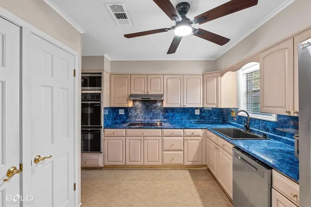 a kitchen with granite countertop stainless steel appliances a sink cabinets and stainless steel appliances
