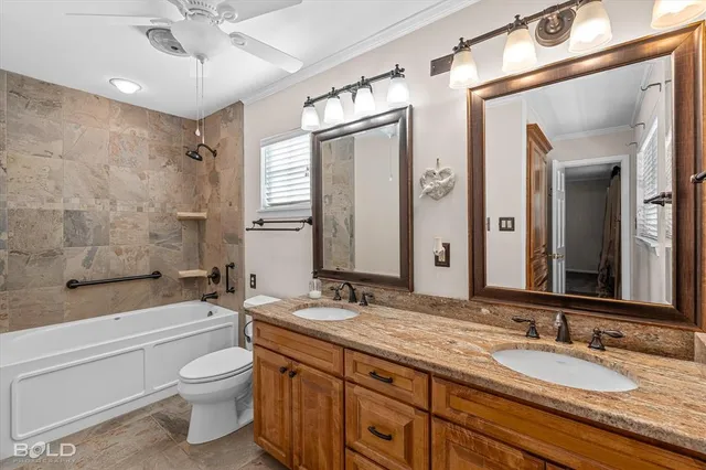 an empty room with chandelier fan and windows
