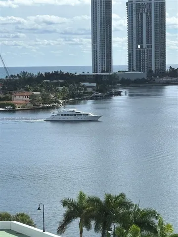 a view of a lake with tall building in the background