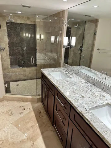 a bathroom with a granite countertop sink a toilet and bathtub
