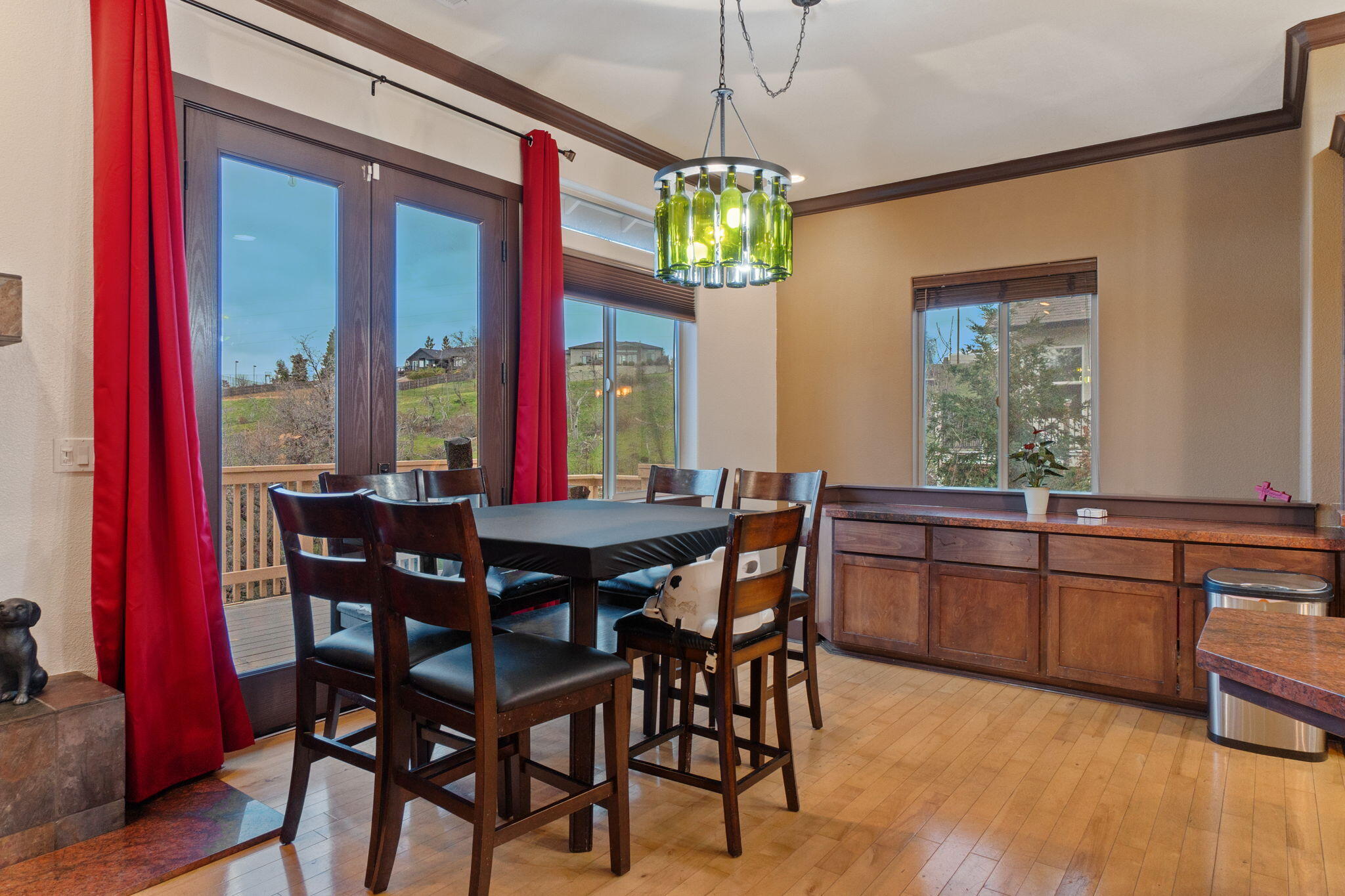 3360 Stanford Drive Redding, CA 96003 - Photo 13 of 56 a view of a dining room with furniture a chandelier and wooden floor
