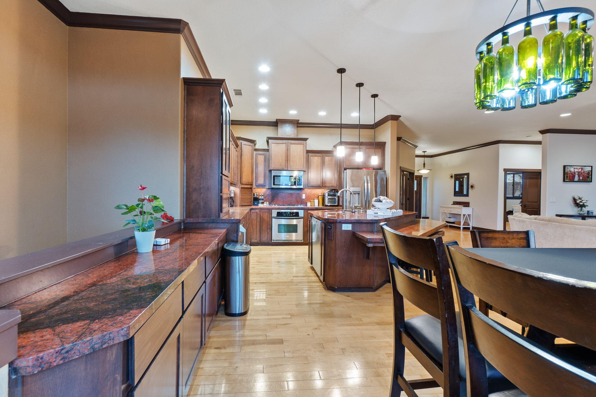 3360 Stanford Drive Redding, CA 96003 - Photo 15 of 56 a kitchen with a dining table chairs and a potted plant