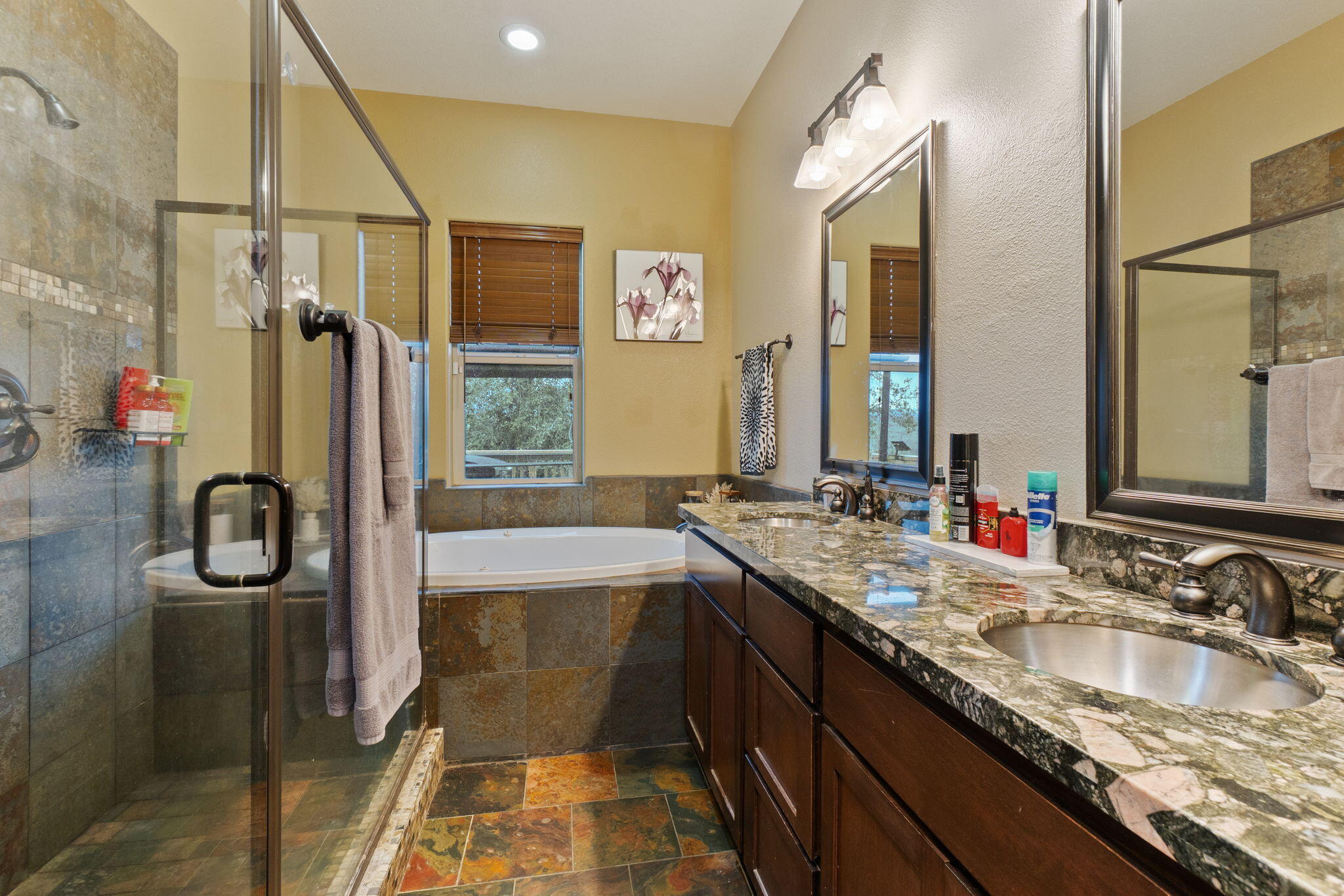 3360 Stanford Drive Redding, CA 96003 - Photo 22 of 56 a bathroom with a granite countertop sink mirror and a bathtub