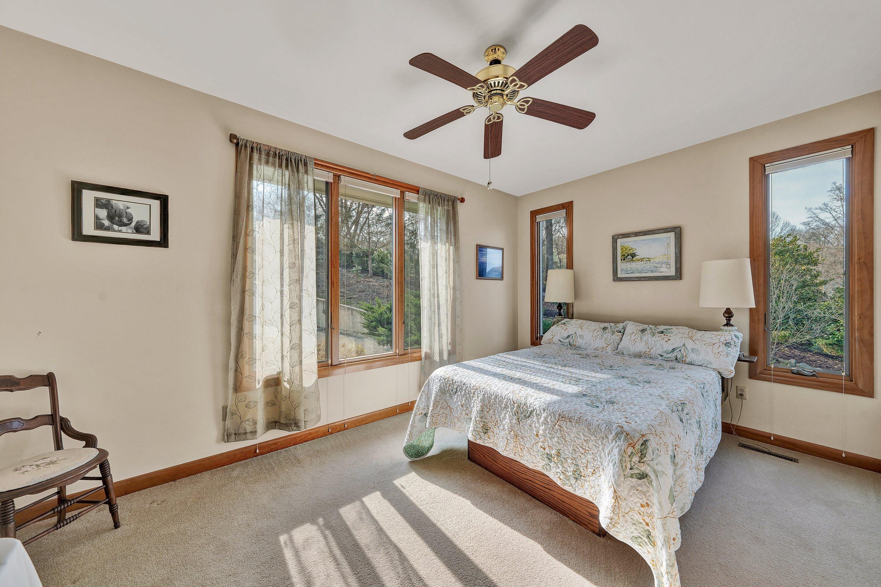 23 Waterpoint Court Moneta, VA 24121 - Photo 18 of 38 a bedroom with a large bed and a large window