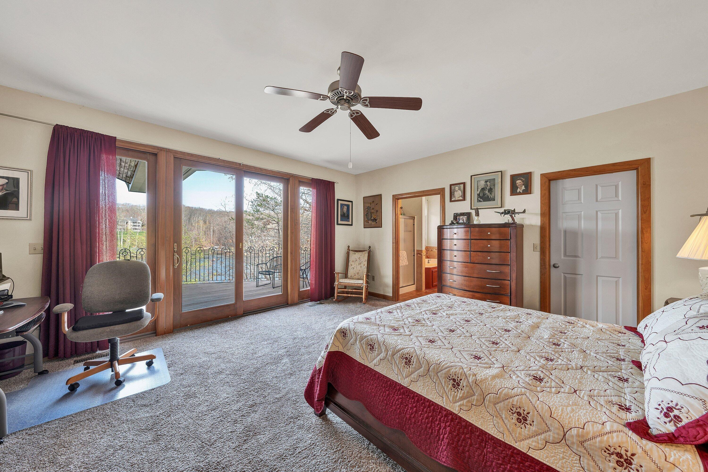 23 Waterpoint Court Moneta, VA 24121 - Photo 19 of 38 a bedroom with a bed and large windows