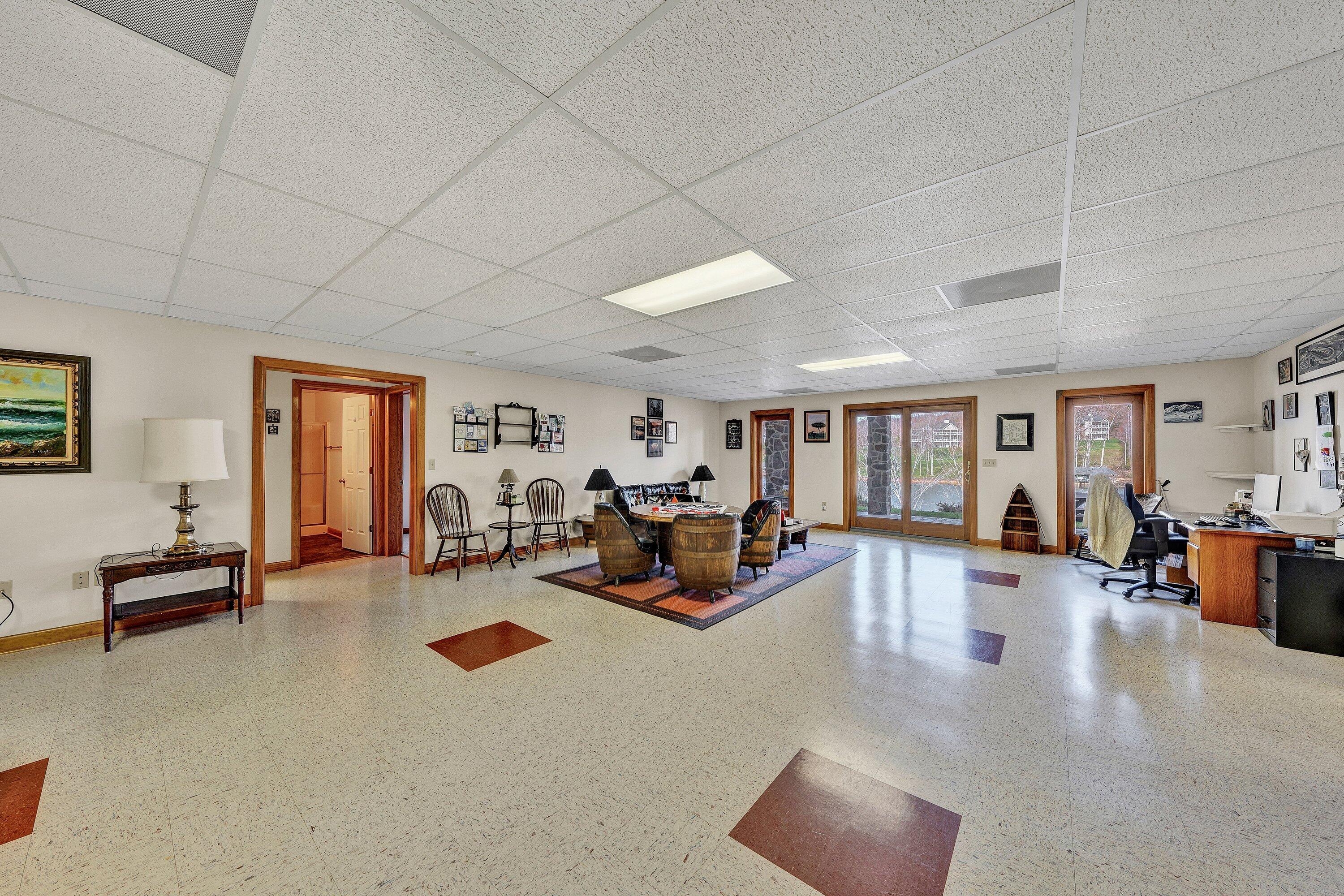 23 Waterpoint Court Moneta, VA 24121 - Photo 24 of 38 a living room with furniture large window and flat screen tv