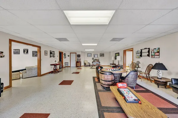 a living room with furniture a rug and gym equipment