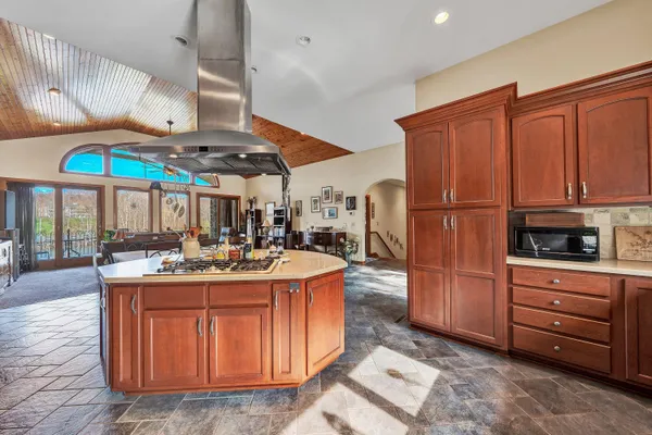 a kitchen with stainless steel appliances granite countertop a stove a sink and a refrigerator
