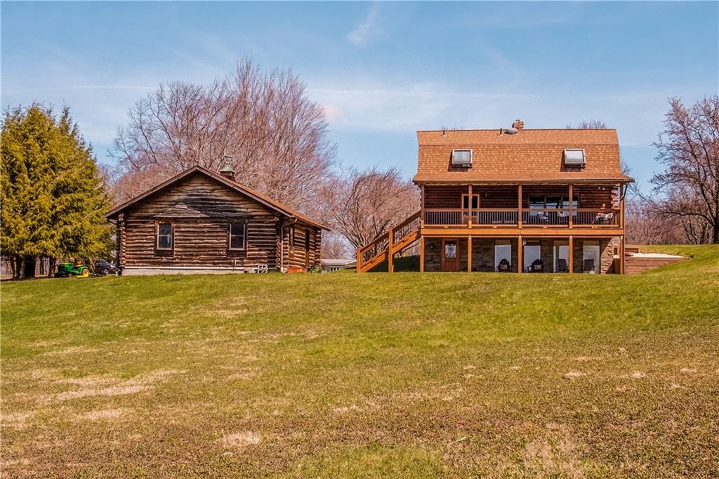 411 Rohrmann Road Darlington, PA 16115 - Photo 23 of 25 a front view of a house with a large tree and a yard
