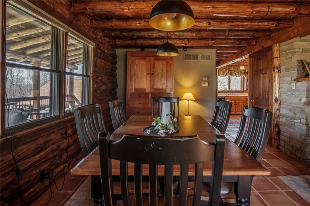 411 Rohrmann Road Darlington, PA 16115 - Photo 6 of 25 a view of a dining room with furniture a chandelier and wooden floor