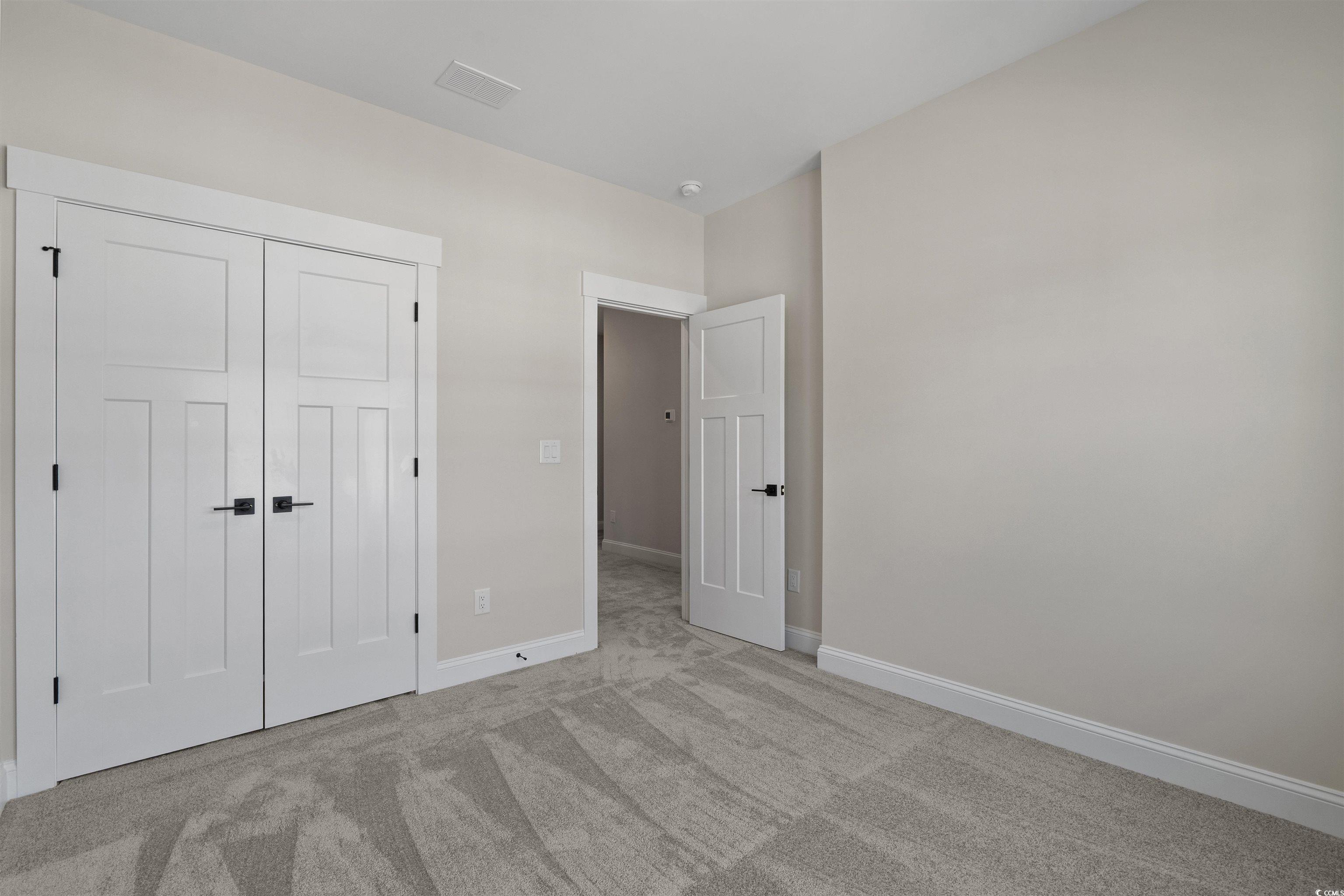 8472 Duke Place, Unit 30 Myrtle Beach, SC 29572 - Photo 32 of 40 Unfurnished bedroom with carpet flooring and a closet