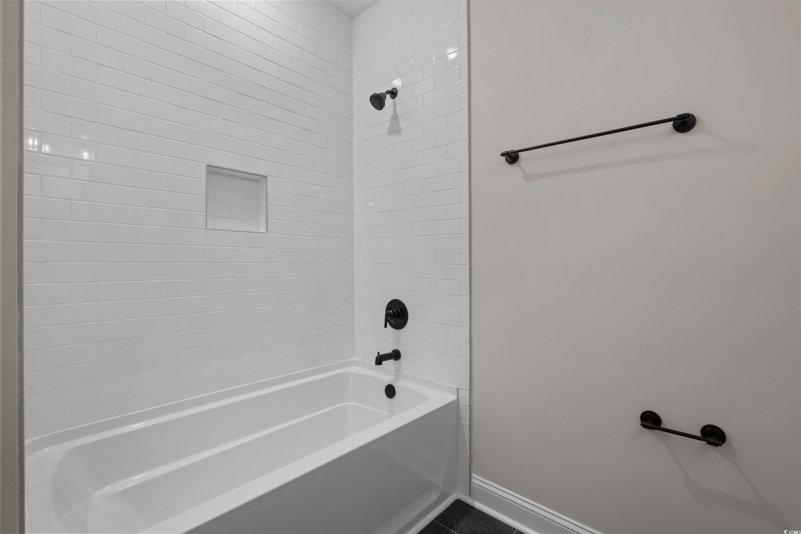 8472 Duke Place, Unit 30 Myrtle Beach, SC 29572 - Photo 34 of 40 Bathroom featuring shower combination and dark tile patterned flooring