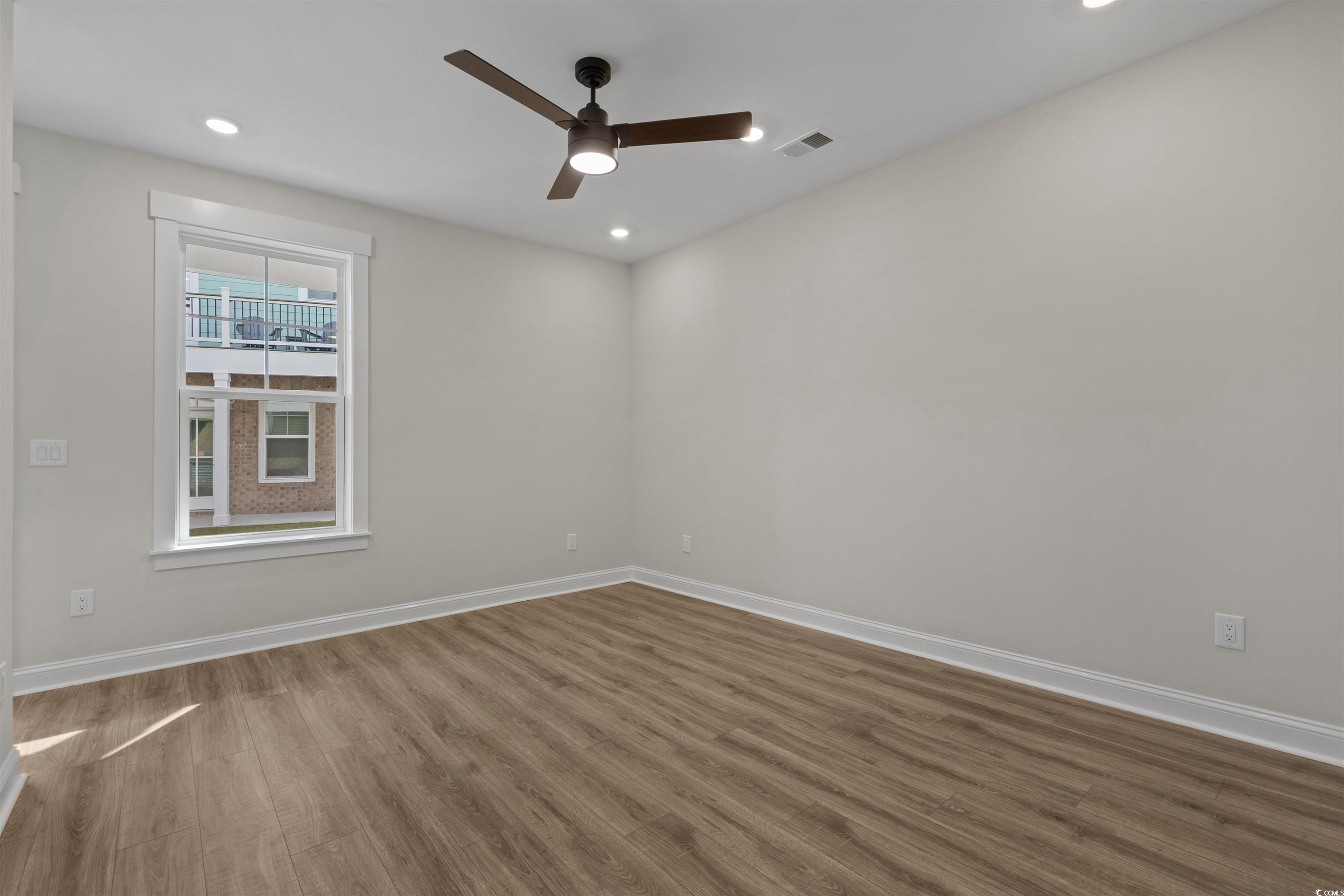 8472 Duke Place, Unit 30 Myrtle Beach, SC 29572 - Photo 36 of 40 Empty room with wood finished floors, recessed lighting, and a ceiling fan