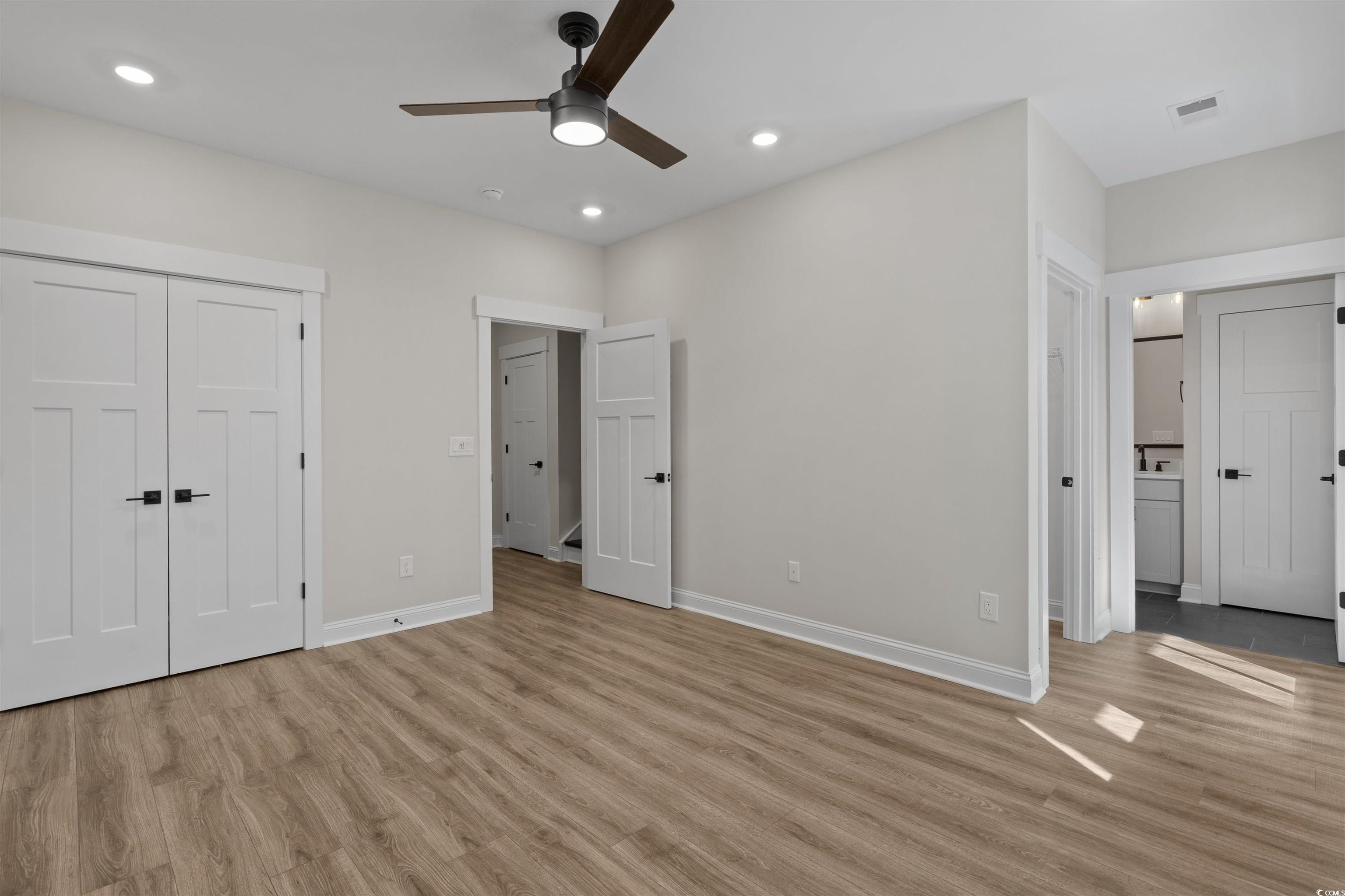 8472 Duke Place, Unit 30 Myrtle Beach, SC 29572 - Photo 37 of 40 Unfurnished bedroom featuring light wood-style flooring, a ceiling fan, recessed lighting, connected bathroom, and a closet