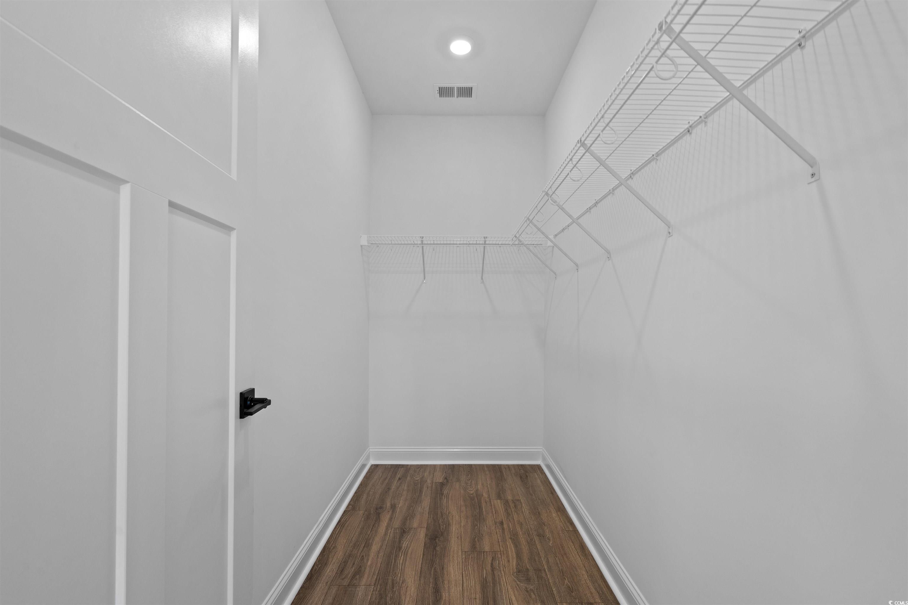 8472 Duke Place, Unit 30 Myrtle Beach, SC 29572 - Photo 38 of 40 Walk in closet featuring dark wood-style floors