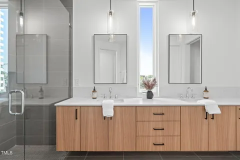 a bathroom with a double vanity sink mirror and double