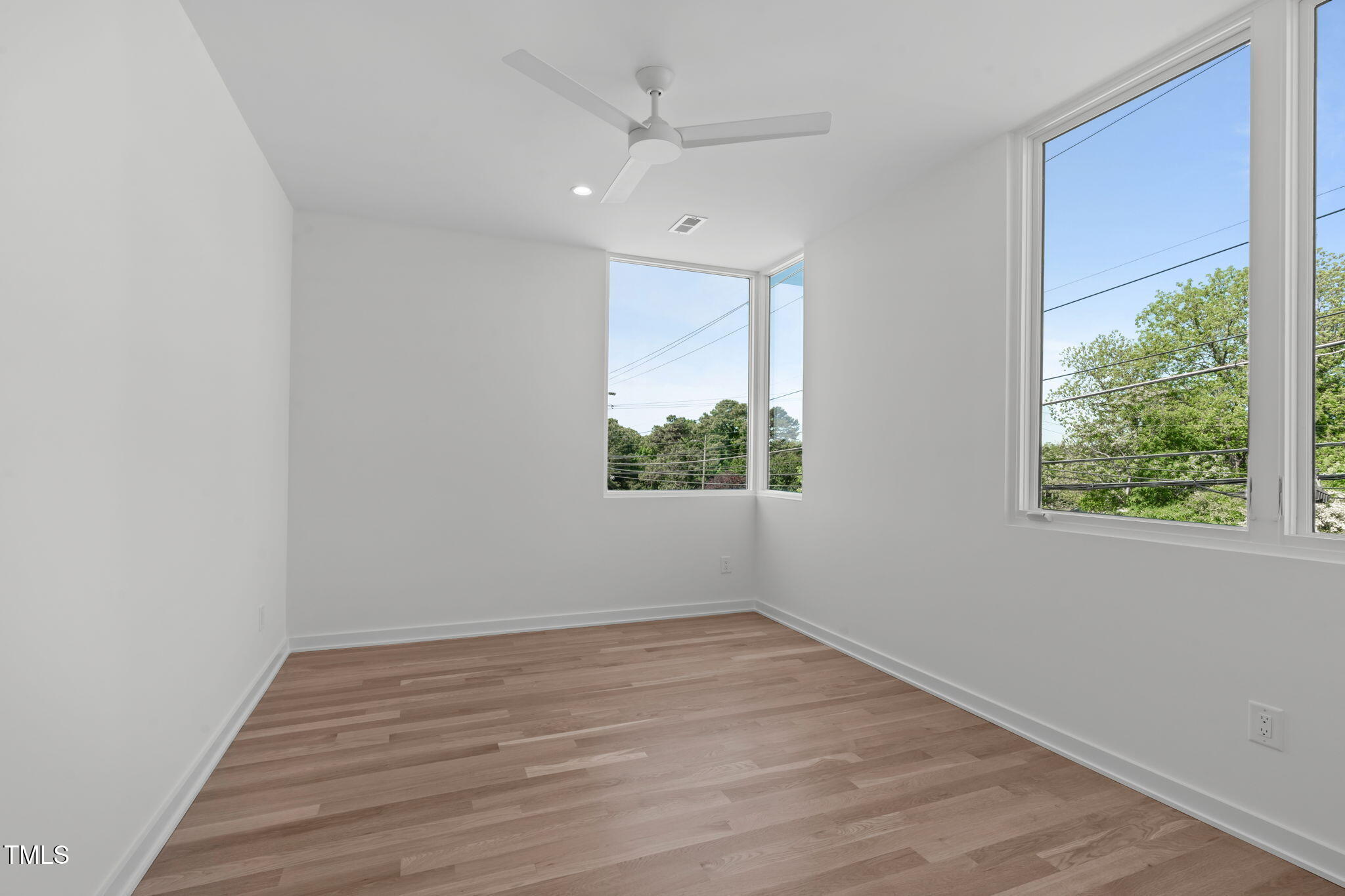 1303 Chamblee Hill Raleigh, NC 27608 - Photo 25 of 49 wooden floor in an empty room with a window